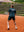 COURT7 Athlet trägt AD-IN Tee Green 200 in Green on-court — T-Shirt